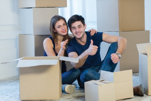 Movers carrying boxes during a Balham flat move